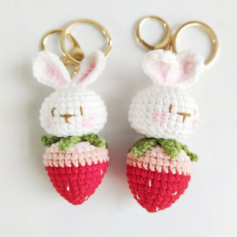 Hand-woven white wire rabbit pendant with strawberry design and key attachment