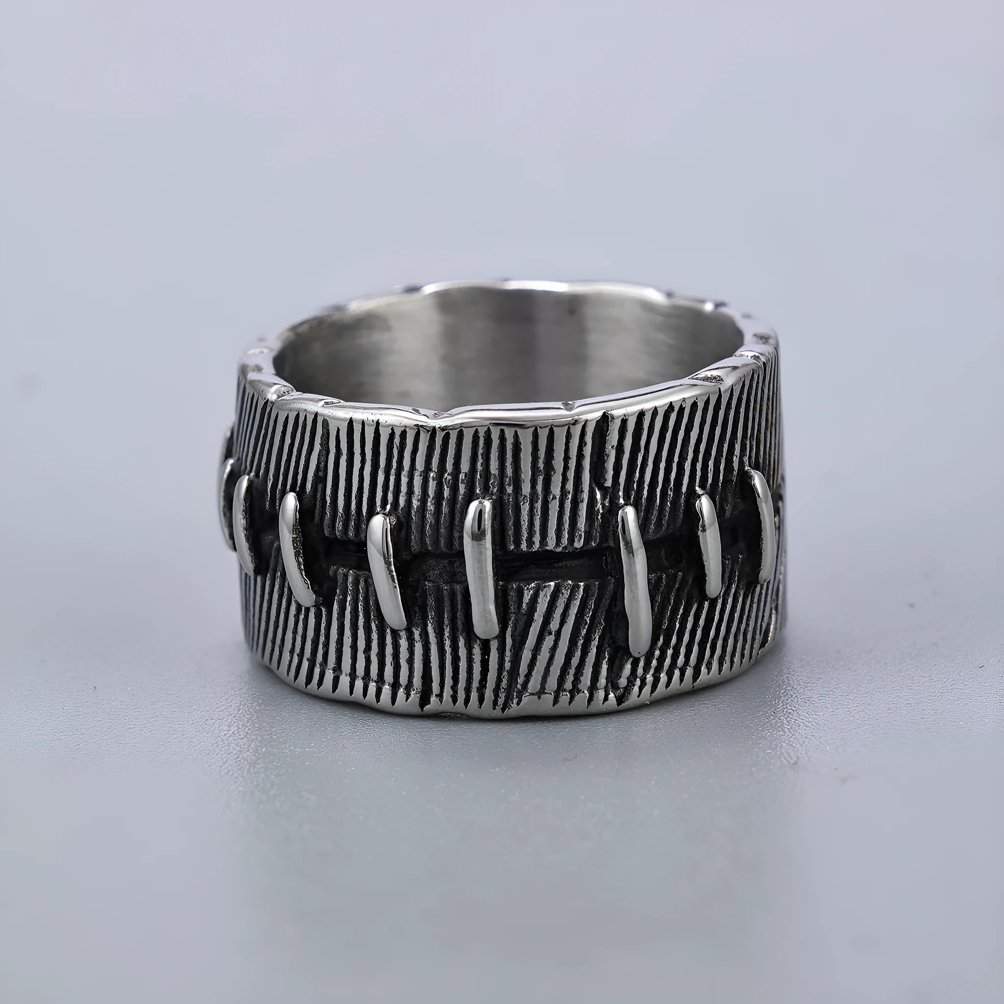Dark punk titanium steel double ring with geometric U-shape design in retro colour on size guide background