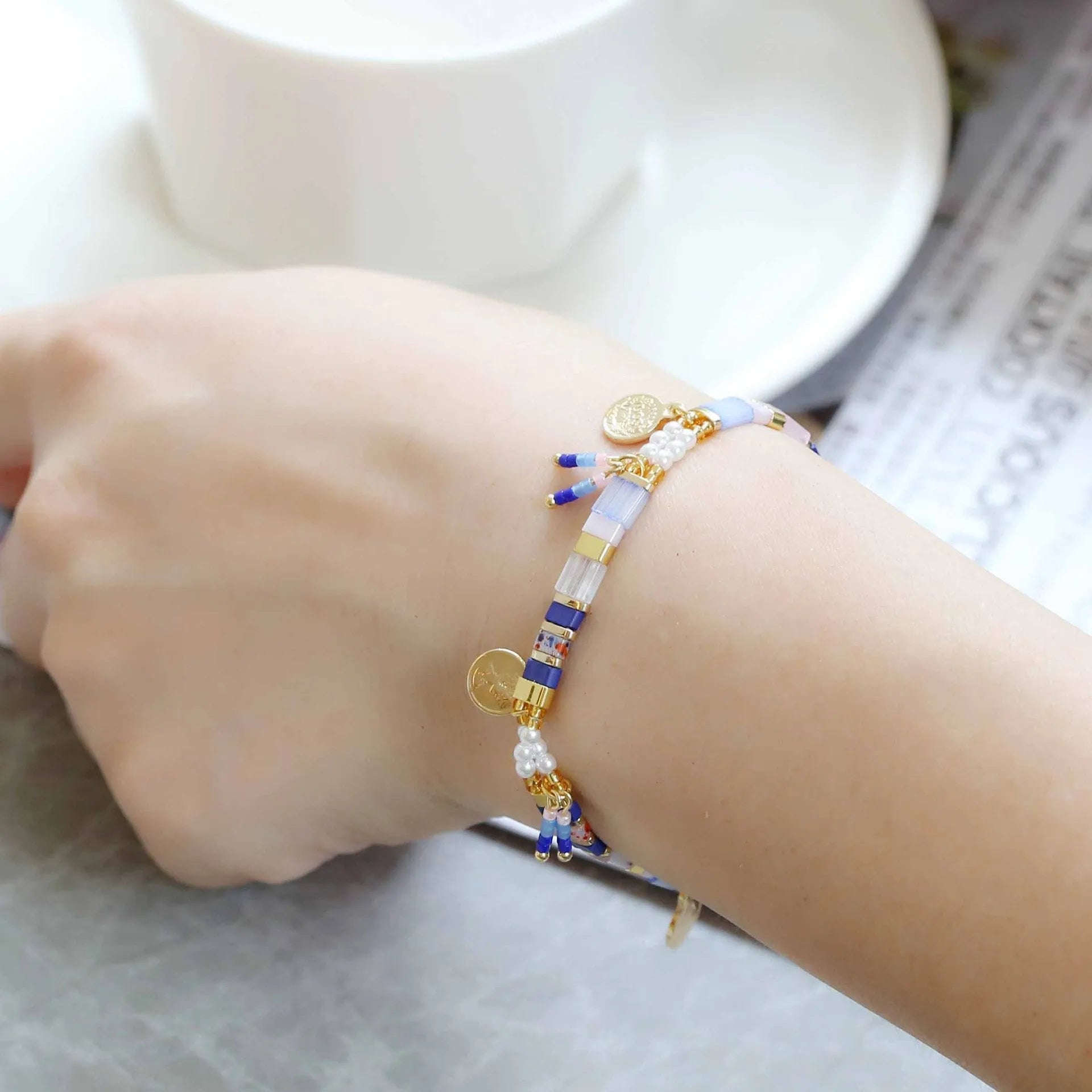Women's handcrafted imitation pearl bracelet shown in one of six available colour variations.