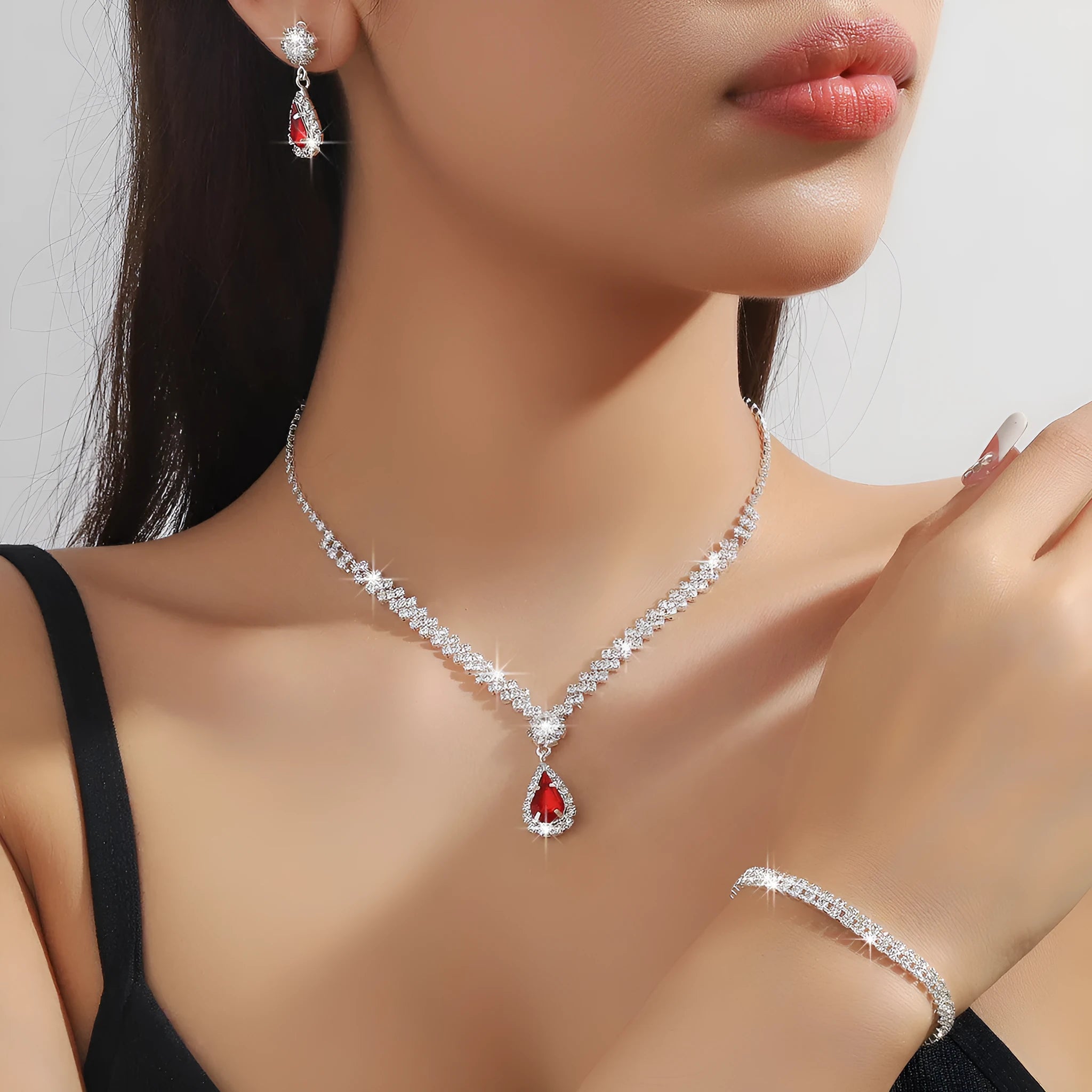 Claw chain rhinestone jewellery set with water drop shapes in a choice of colours, showing necklace, earrings, and optional bracelet.