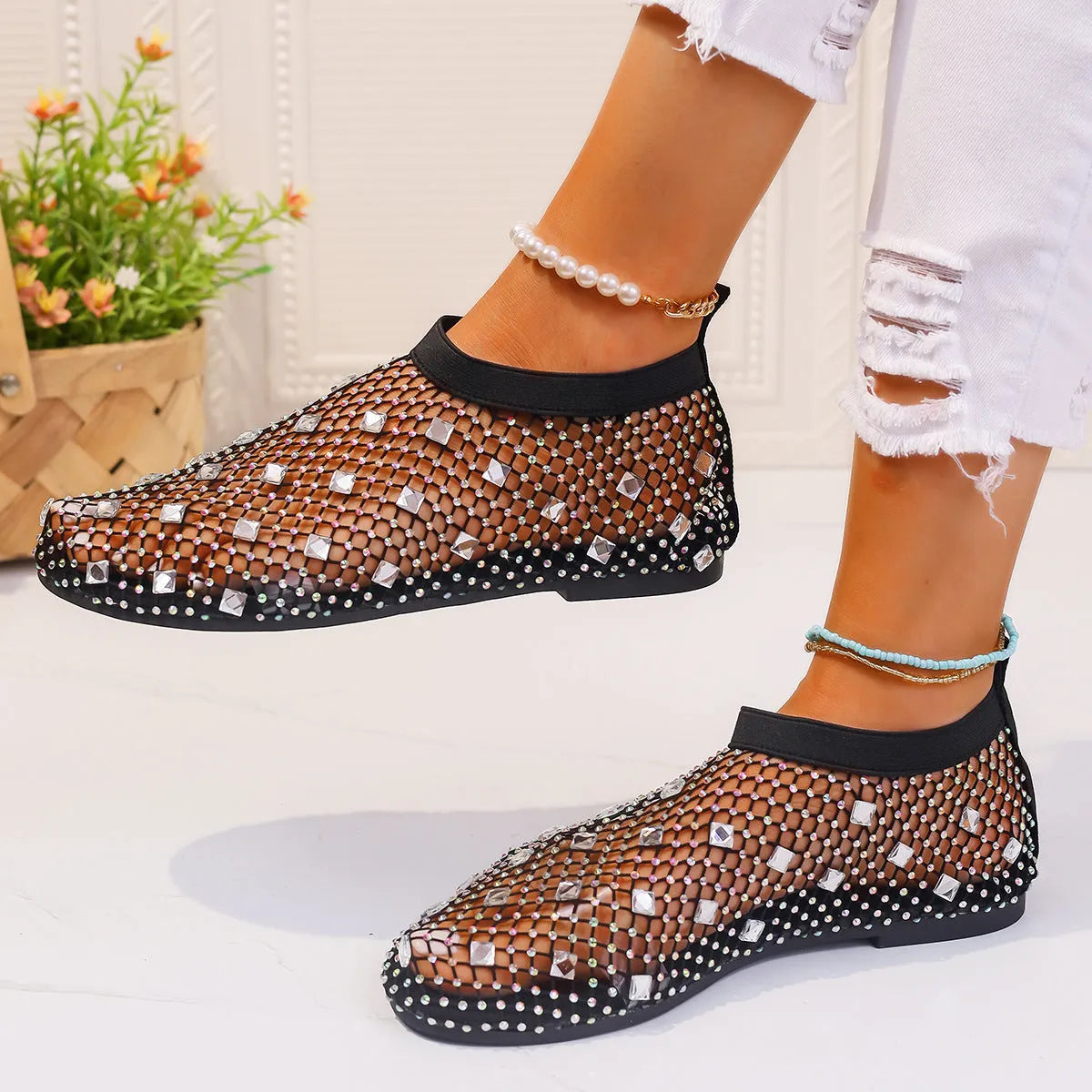 Women's flat sandals with mesh upper, colourful rhinestone detail, and a round toe.