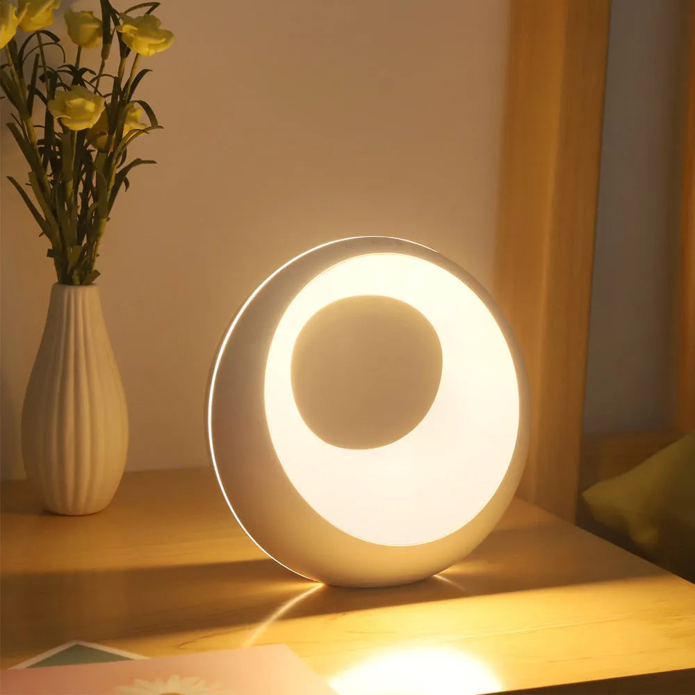 Small RGB colour changing desk lamp with remote control on wooden surface
