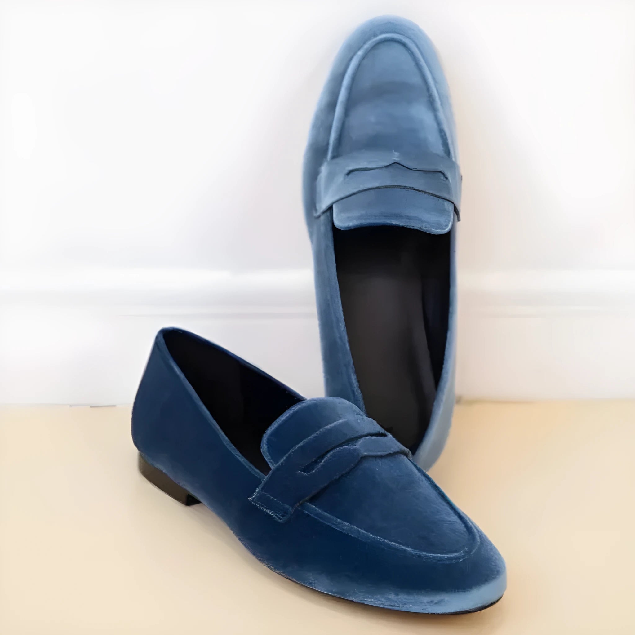 Blue and black women's slip-on loafers with a round toe and rubber sole.