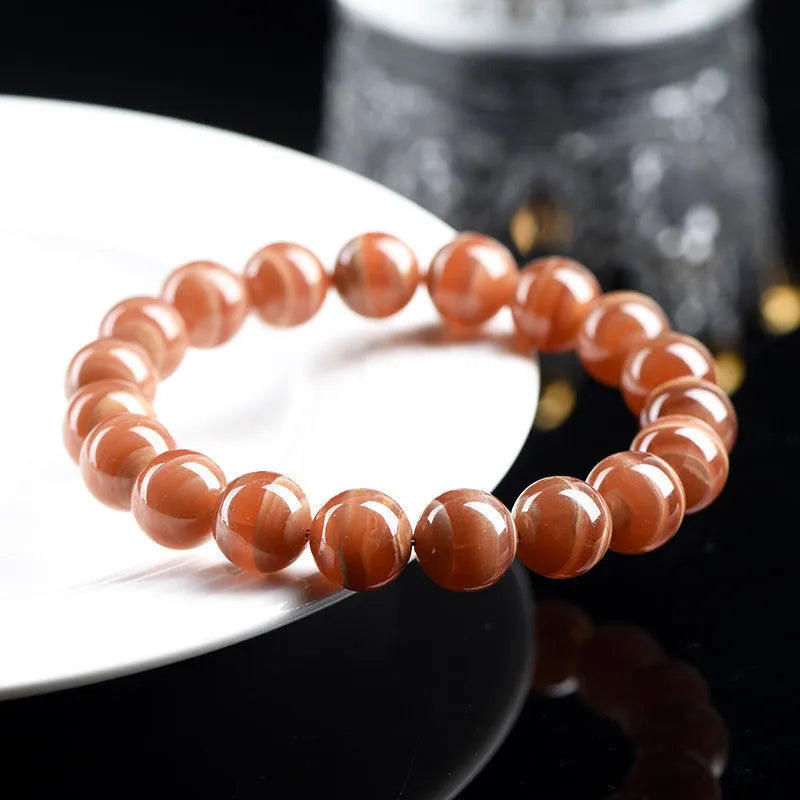 Natural old mine rhodochrosite round bead bracelet with Ruyi charm, Peruvian mineral jewellery.
