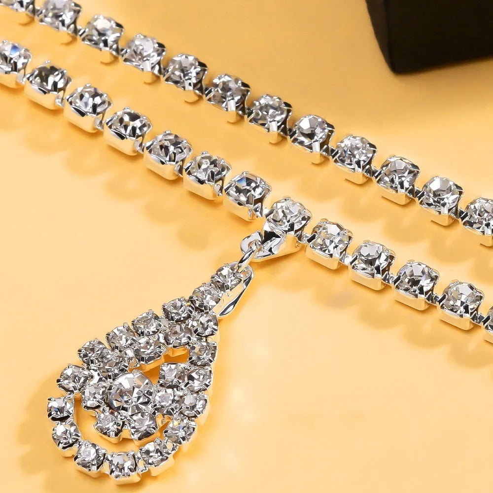 Women's gold rhinestone waist chain with water drop pendant and tassel details
