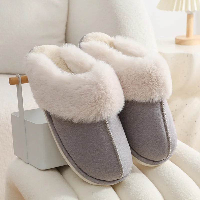 A pair of round-toe flat-heel plush slippers with stitching detail, shown in one of five available colours.