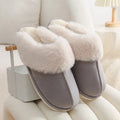 A pair of round-toe flat-heel plush slippers with stitching detail, shown in one of five available colours.