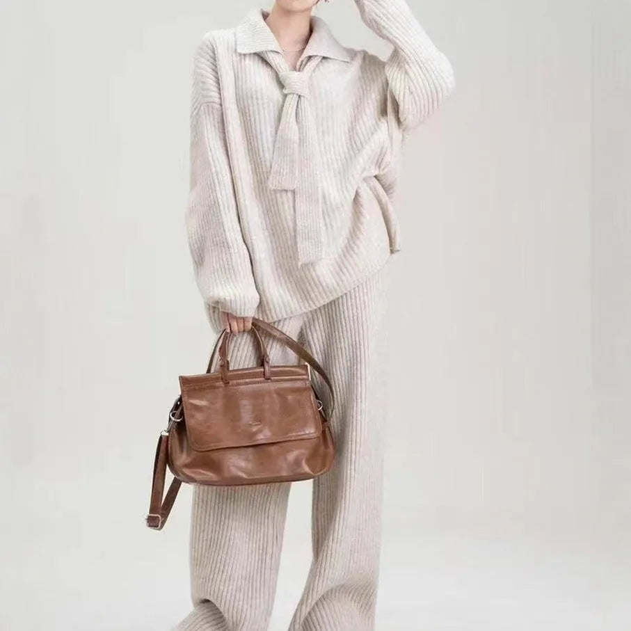 Women's dark grey knit top and trousers two-piece sweater suit set on a hanger