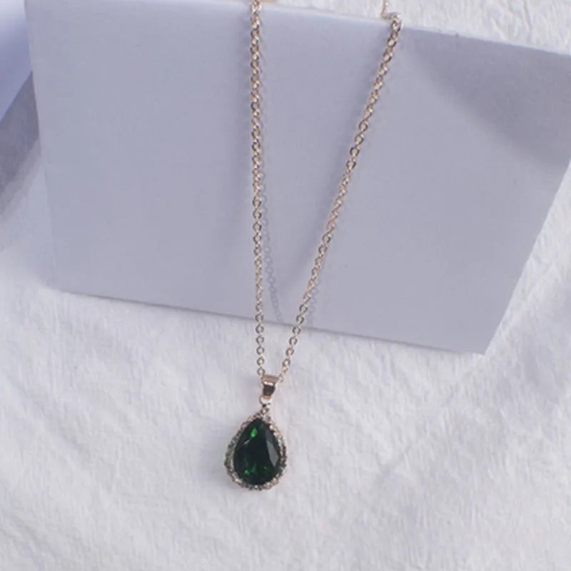 Women's geometric drop shape pendant necklace with rhinestone detail in pink electroplated finish.