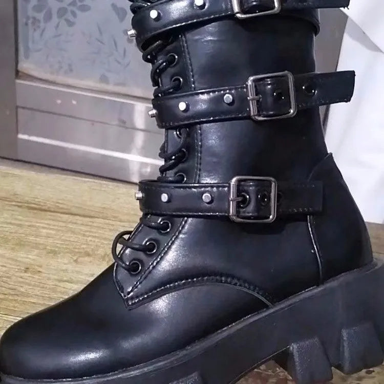 A pair of black mid-calf women's boots with metal buckle details and a side zipper on a white background.