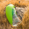 Portable blue pet drinking water bottle with attached bowl and carabiner clip for outdoor use