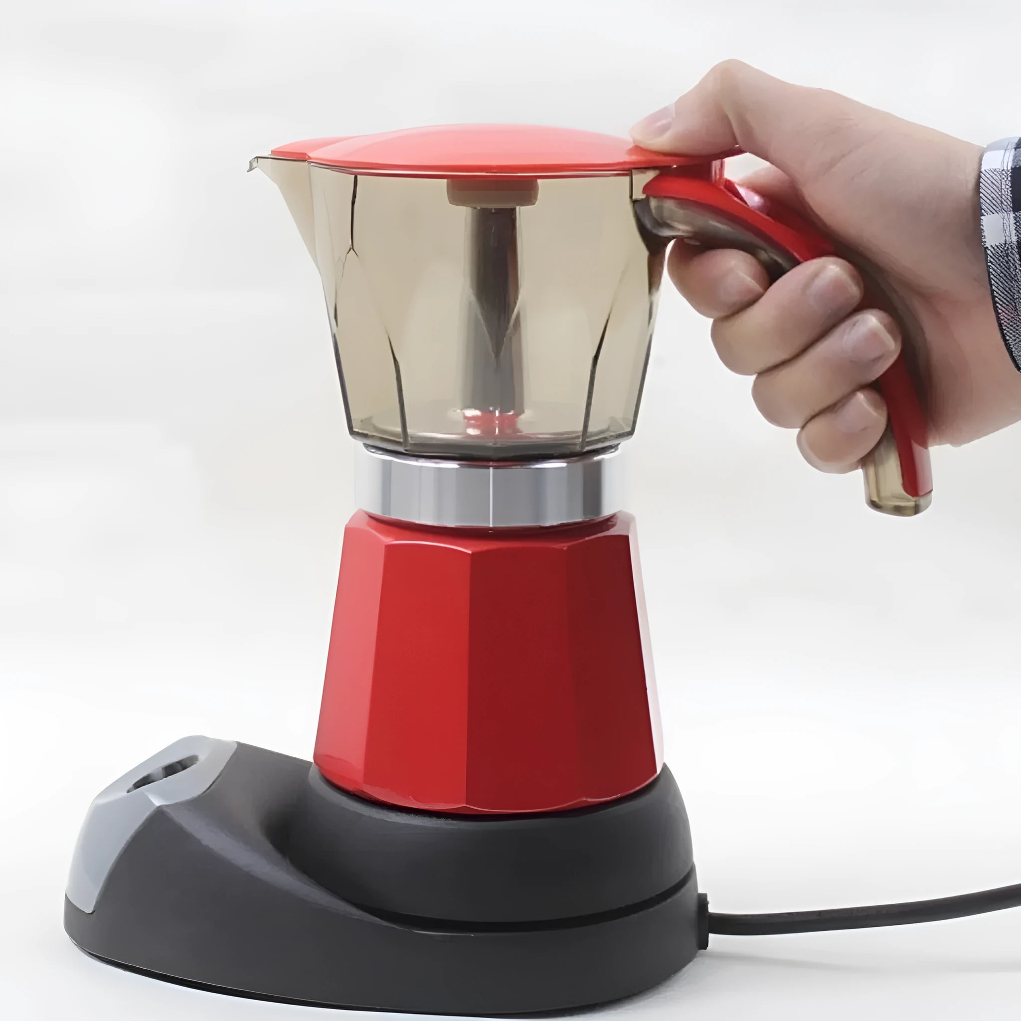 Octagonal electric Moka pot in silver aluminium with EU plug on a kitchen countertop