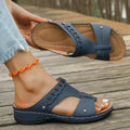 Casual blue Roman style slippers on a white background, showing slope heel and fish mouth toe design.