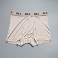 Man wearing loose-fitting mid-waist silk shorts in navy blue, silver grey, or skin colour.