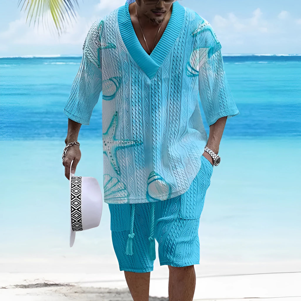 Man wearing a loose blue short sleeve suit top and matching shorts for casual summer wear.