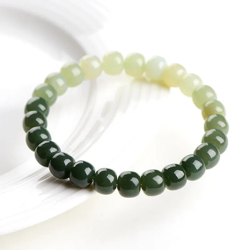 Natural Hetian jade bracelet with water gradient colours on wrist.