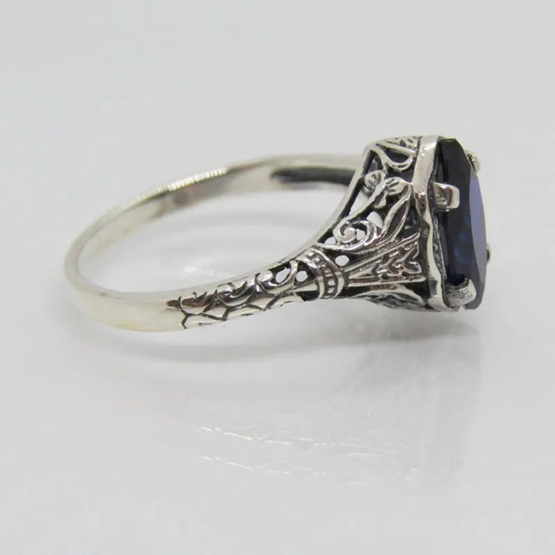 Silver geometric hollow women's ring on a hand, showing its alloy and electroplated construction.