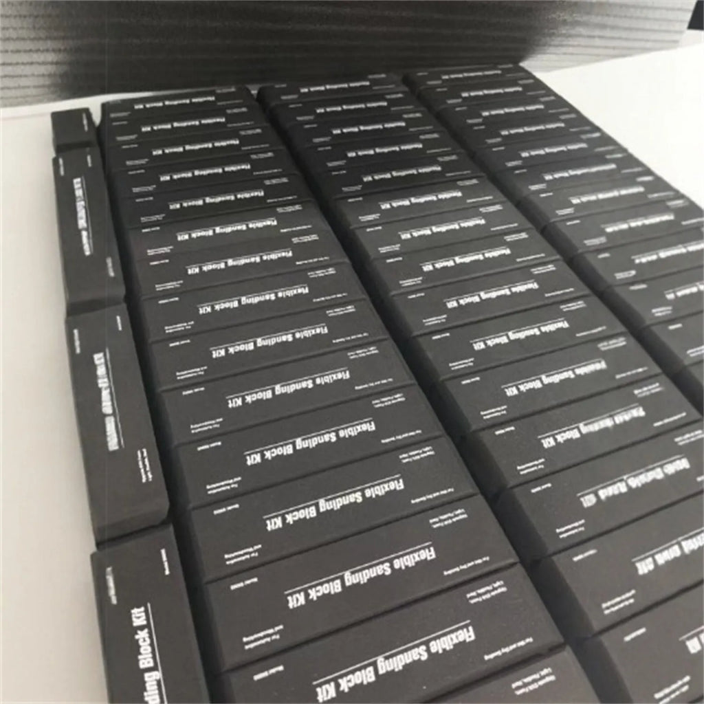 Seven black metal EVA frosted building blocks arranged together showing matte surface texture