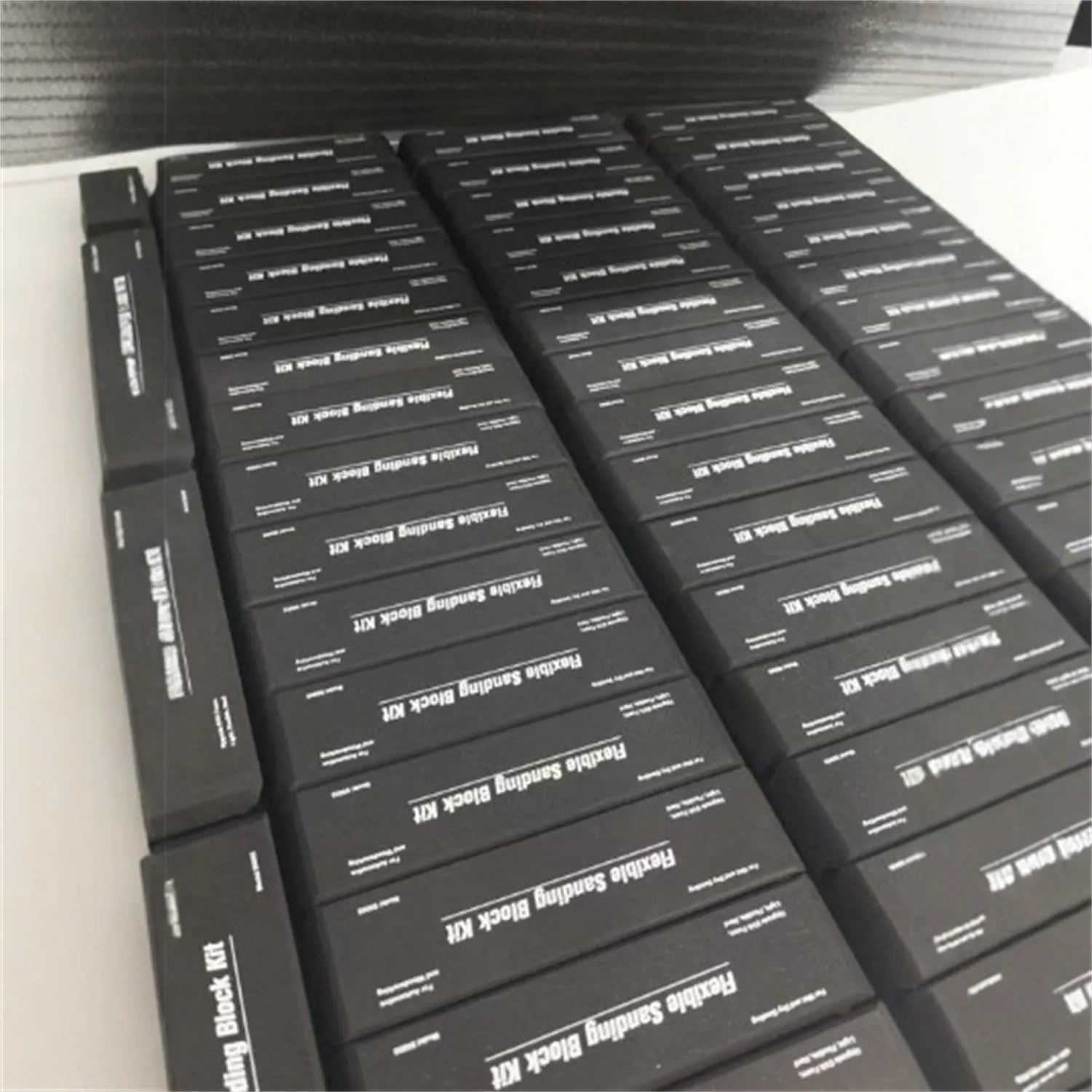 Seven black metal EVA frosted building blocks arranged together showing matte surface texture