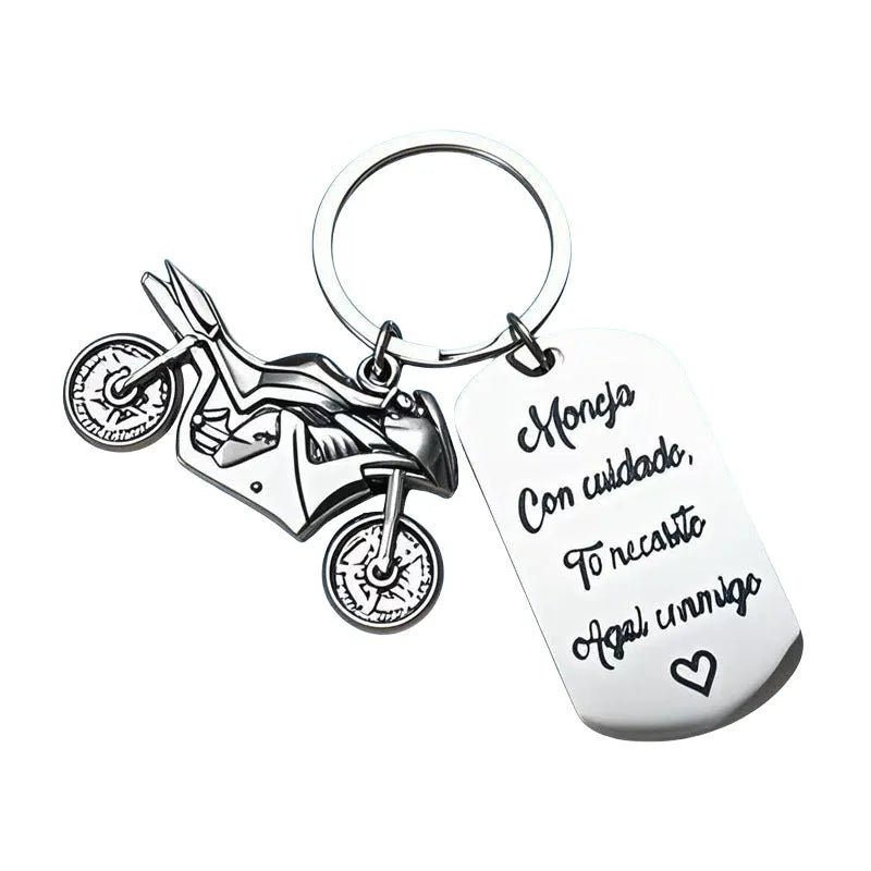 Stainless steel motorcycle keychain with inspirational charm on a flannel bag.