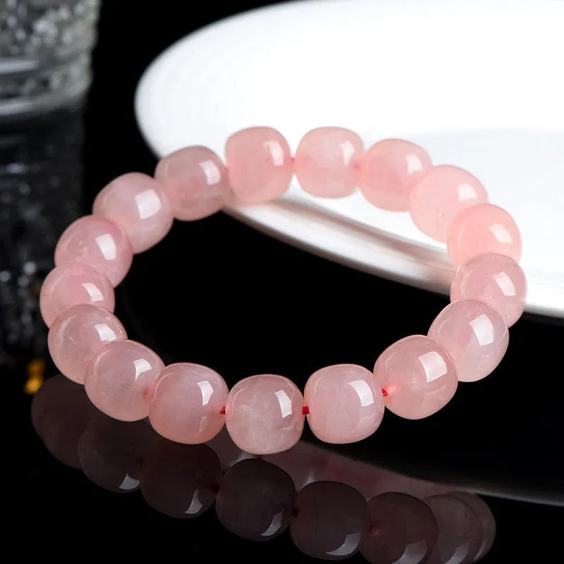 Pink natural crystal barrel bead bracelet with geometric shapes measuring 8-10mm