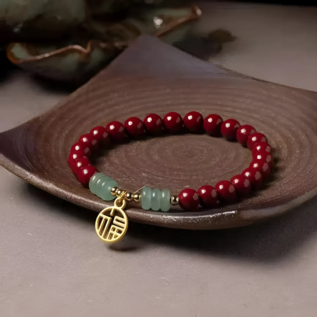 Handmade wave-shaped bracelet in cinnabar and copper beads on a wrist.