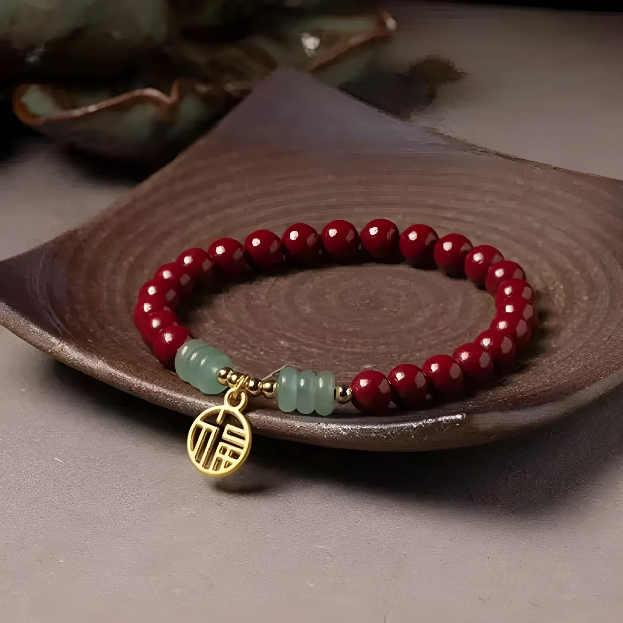 Handmade wave-shaped bracelet in cinnabar and copper beads on a wrist.