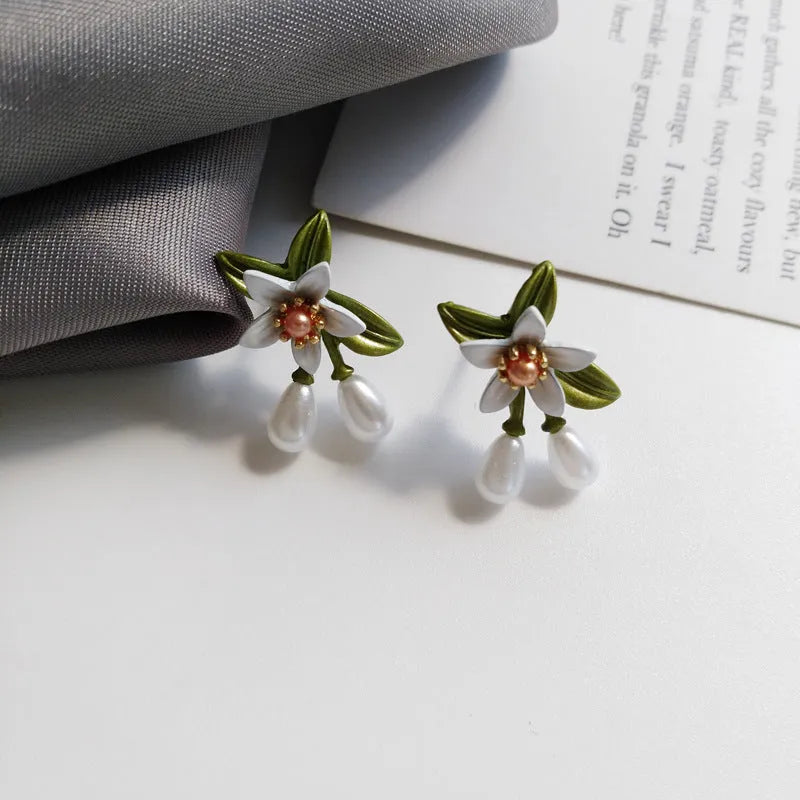 Alloy camellia flower earrings with colour contrast design showing both ear stud and ear clip configurations