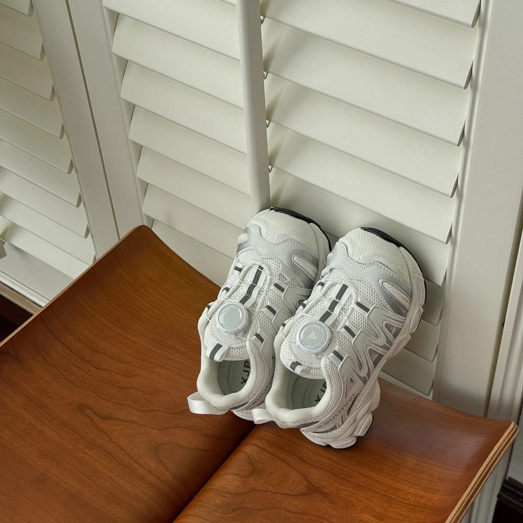 Girls lightweight casual sneaker in PU leather mesh, shown in solid black, beige, or pink.
