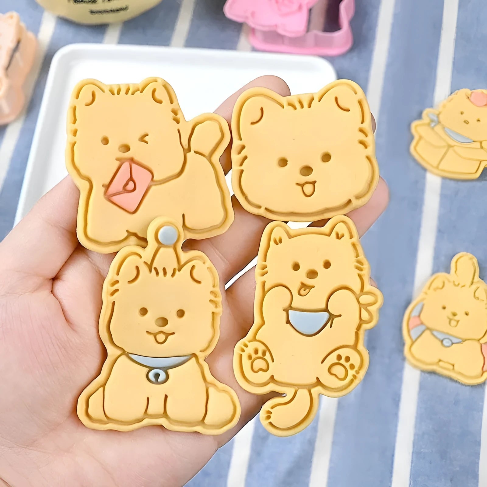 Plastic 3D cartoon puppy biscuit mould showing seven style variations including birthday hat and swimming ring designs