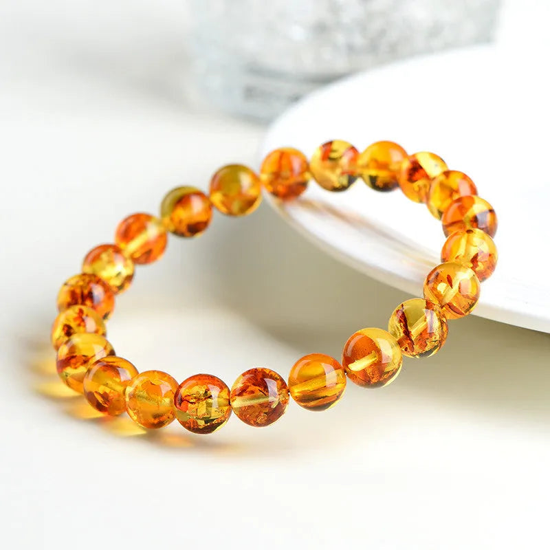 Natural yellow piebald amber bracelet with flower spot patterning in three bead size options