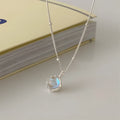 Women's sterling silver necklace with round geometric pendant on an adjustable curb chain.