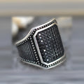 Black alloy ring with copper inlay and zircon stone detail shown in unisex design