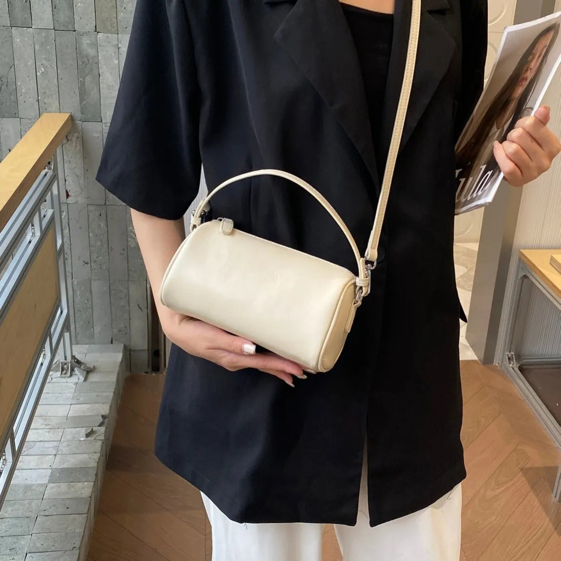 Genuine leather crossbody phone bag in cylindrical shape with single shoulder strap