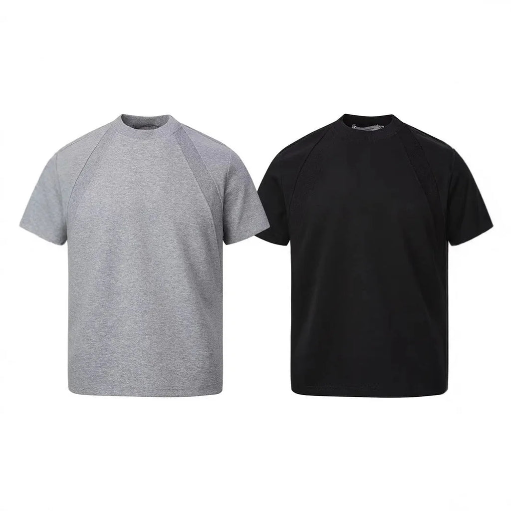 Black loose fit short sleeve top with air layer stitching detail on a hanger