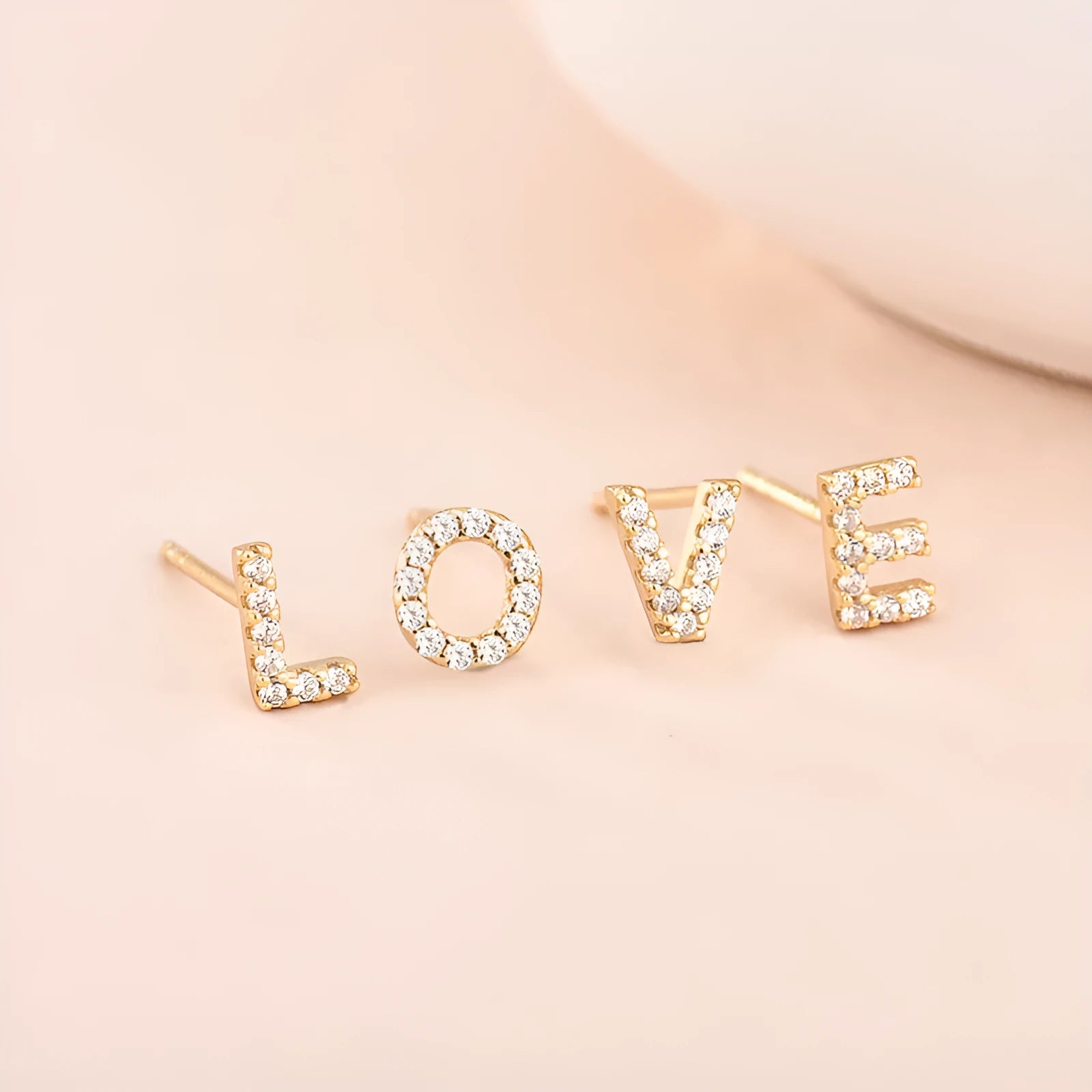 Brass gold plated alphabet letter earrings showing English characters from A to Z options