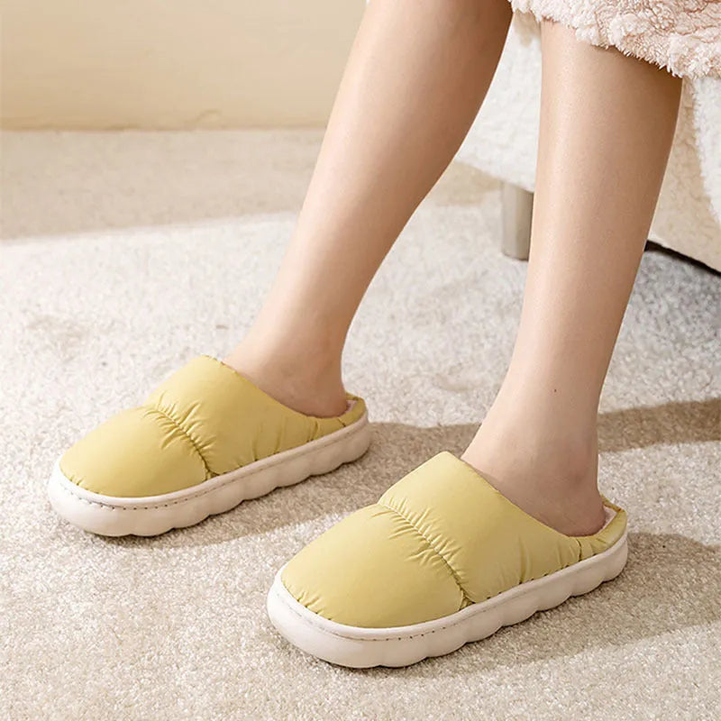 Blue winter slippers for indoor use with a thick rubber non-slip sole and artificial plush lining.