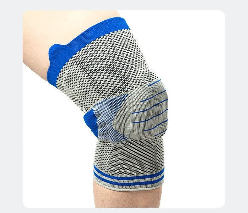 Close-up of a grey and blue cotton knee pad showing the silicone massage spring bar and shock absorber design.