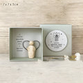 Boxed resin and plastic guardian angel figurine ornament in a modern cartoon style.