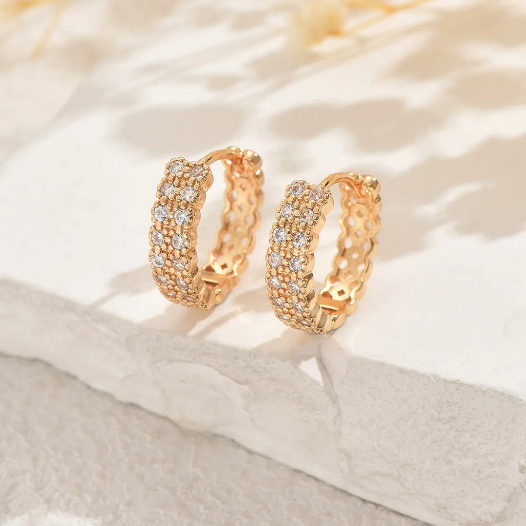 Geometric pattern copper ear studs in colour DE20288 with round, dot, and ring details.