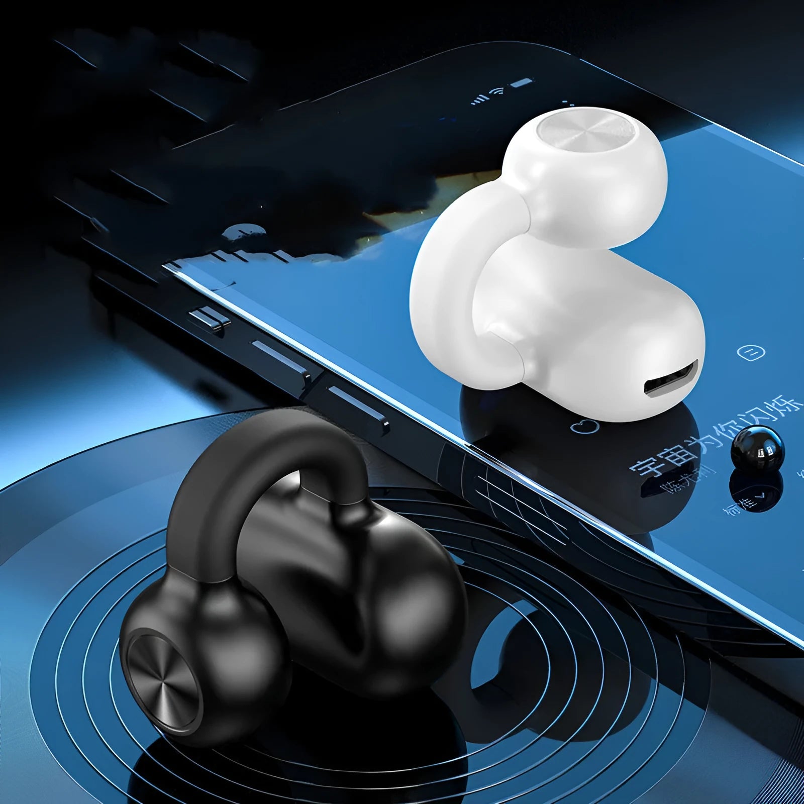 Black wireless bone conduction clip-on bluetooth earphones with charging cable on white background