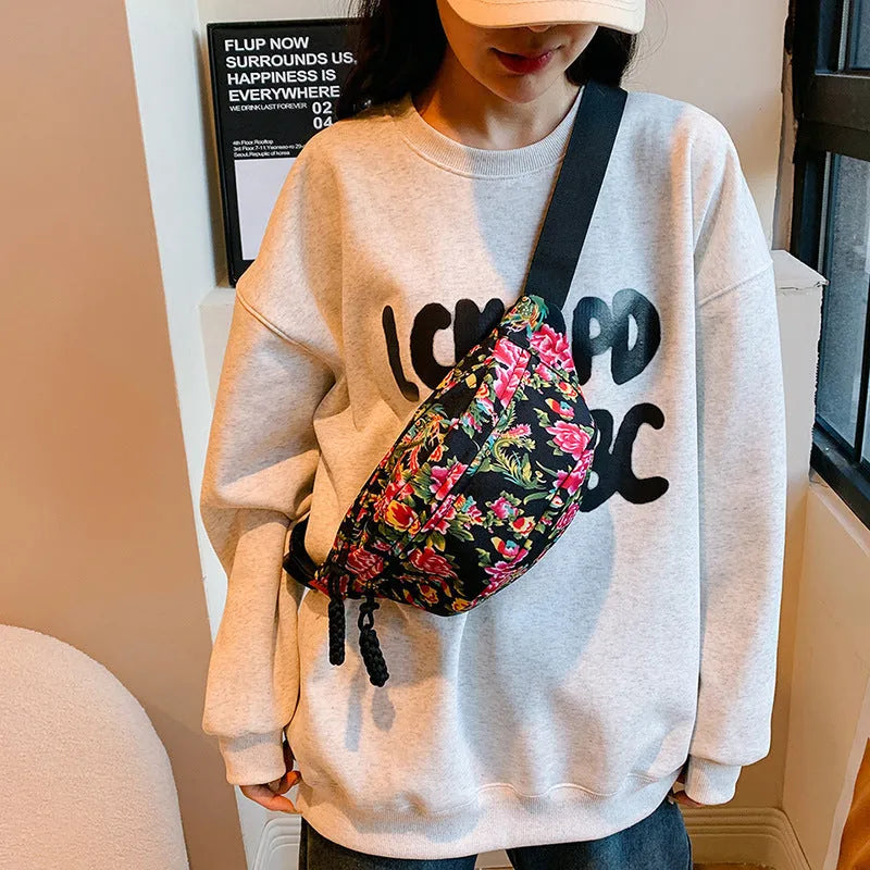 Women's Western-style floral waist bag in nylon with adjustable strap showing contrast stitching