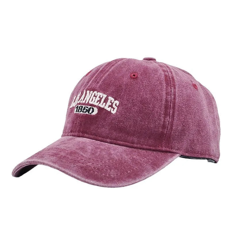 Retro distressed peaked cap with embroidered letters and adjustable strap in multiple colour options