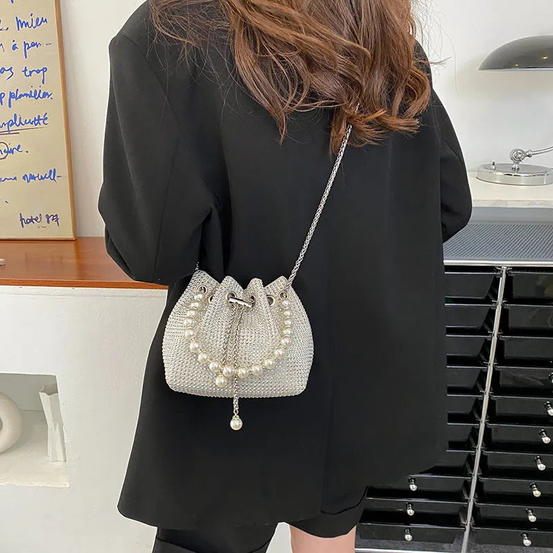 Western style diamond pattern PU leather crossbody bucket bag in black, showing chain strap and external pockets.