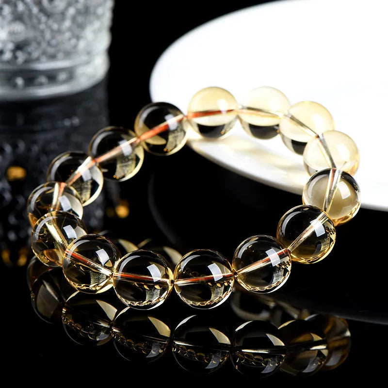 Natural citrine scattered bead ball bracelet showing 7A and 6A colour grades on a model's wrist.