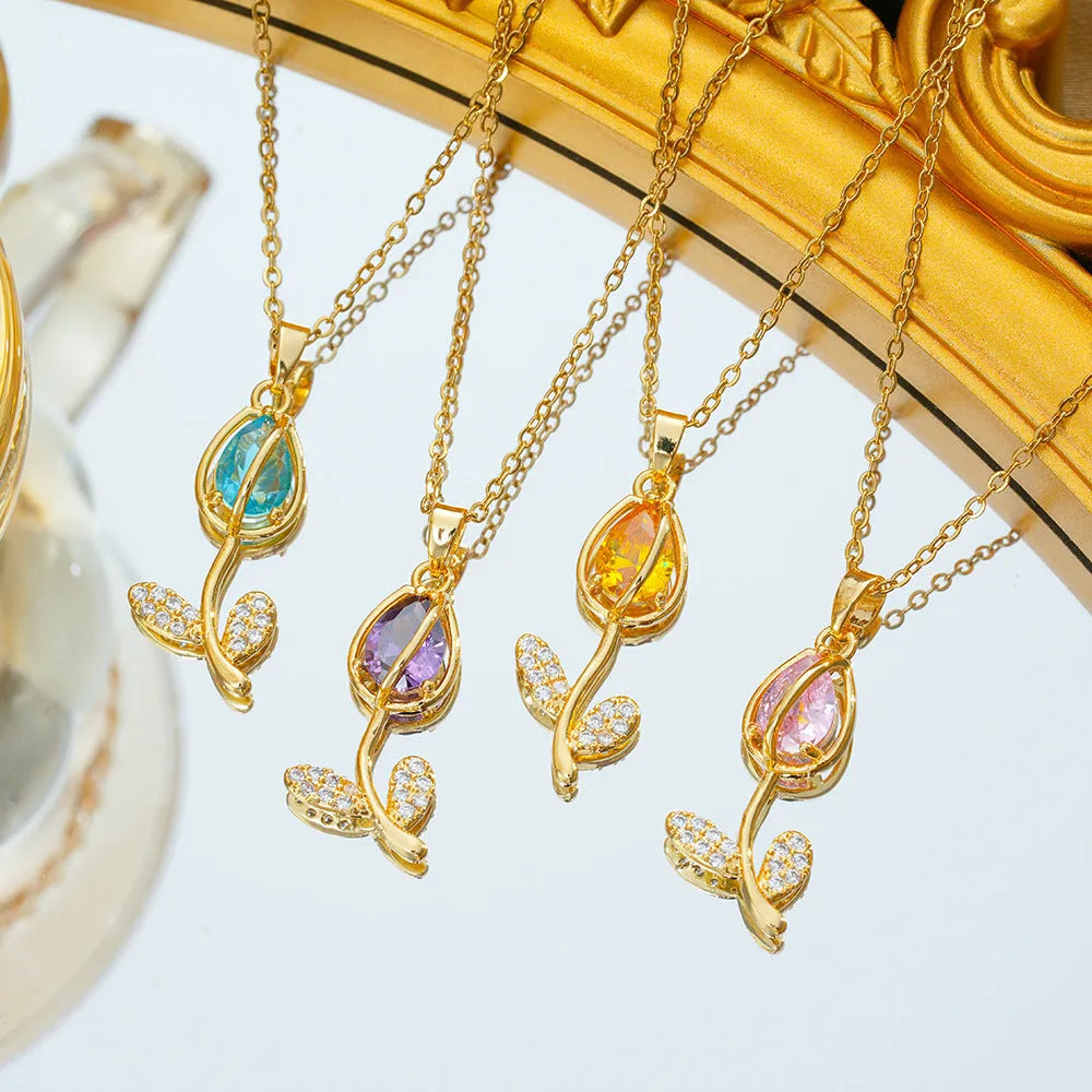 Zircon tulip pendant necklace for women in electroplated gold colours on an adjustable O-ring chain.