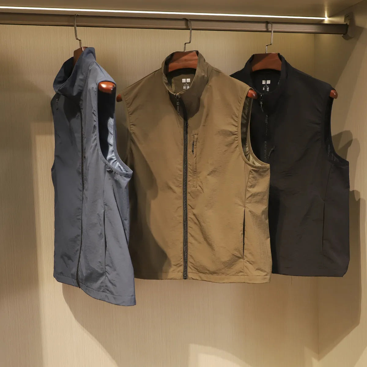 Men's straight cut nylon vest in army green with side seam pockets and cardigan style front