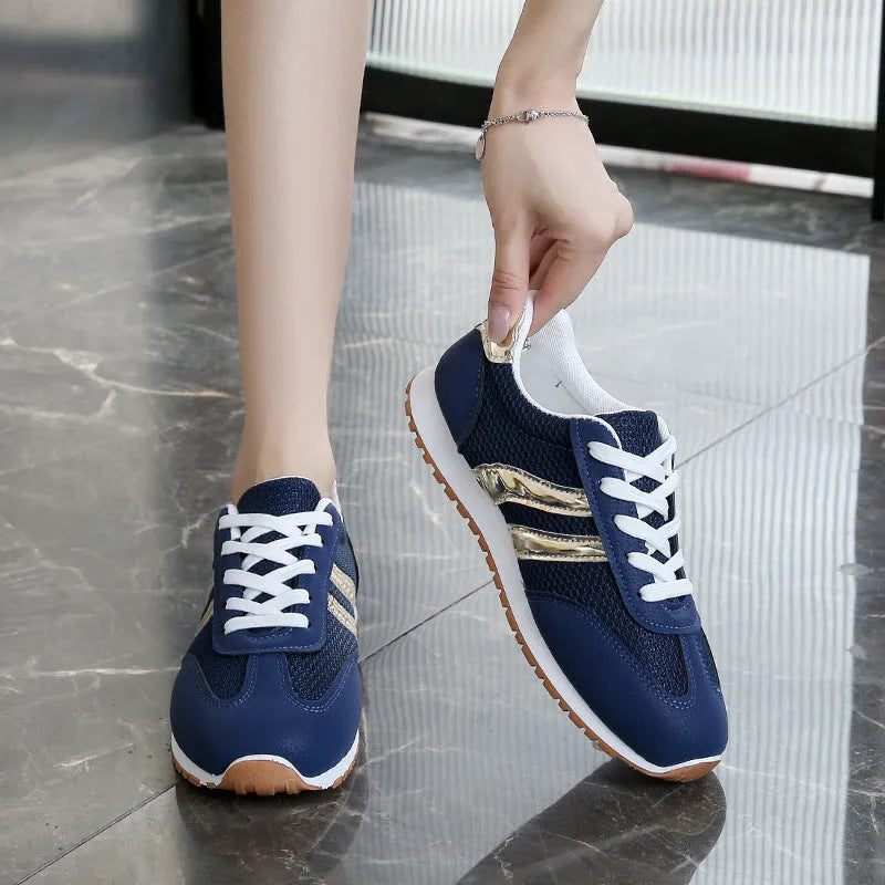 Blue women's casual tennis shoes with cross shoulder straps and white rubber sole.