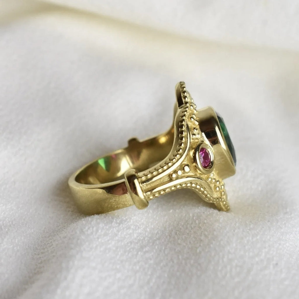 Golden geometric women's ring on a plain background, showing its alloy construction and electroplated finish.