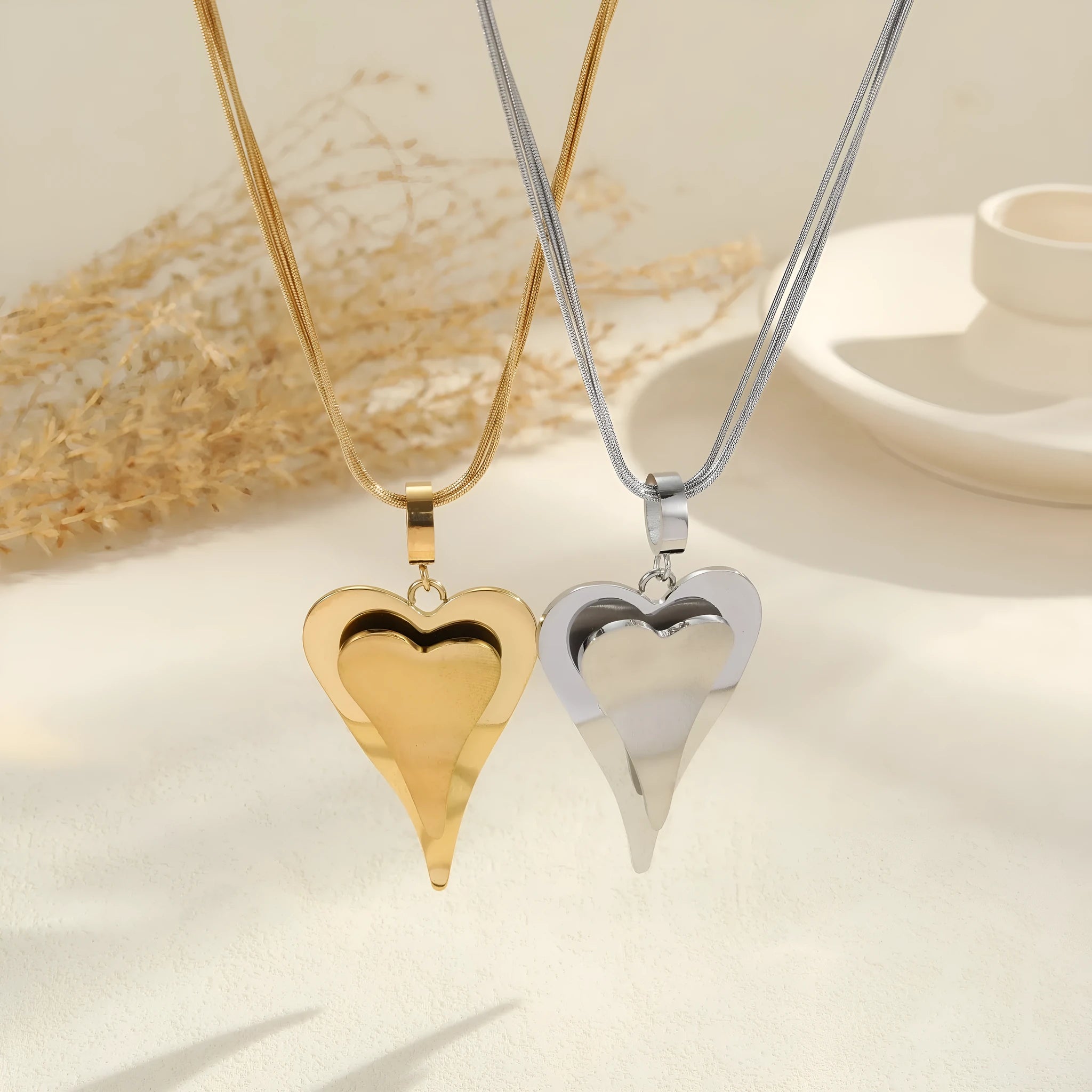 Geometric double heart and snake bones necklace in stainless steel with gold or steel finish on regular chain
